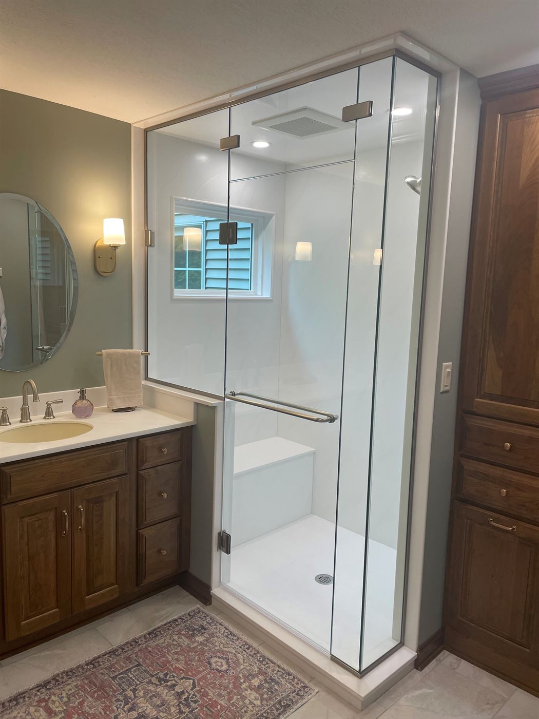 Corner glass shower and vanity remodel by Stellar Construction