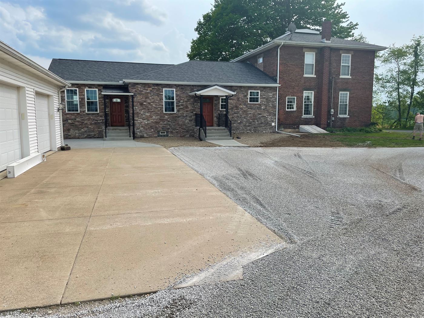 Stone-front room addition joined to an existing home by Stellar Construction